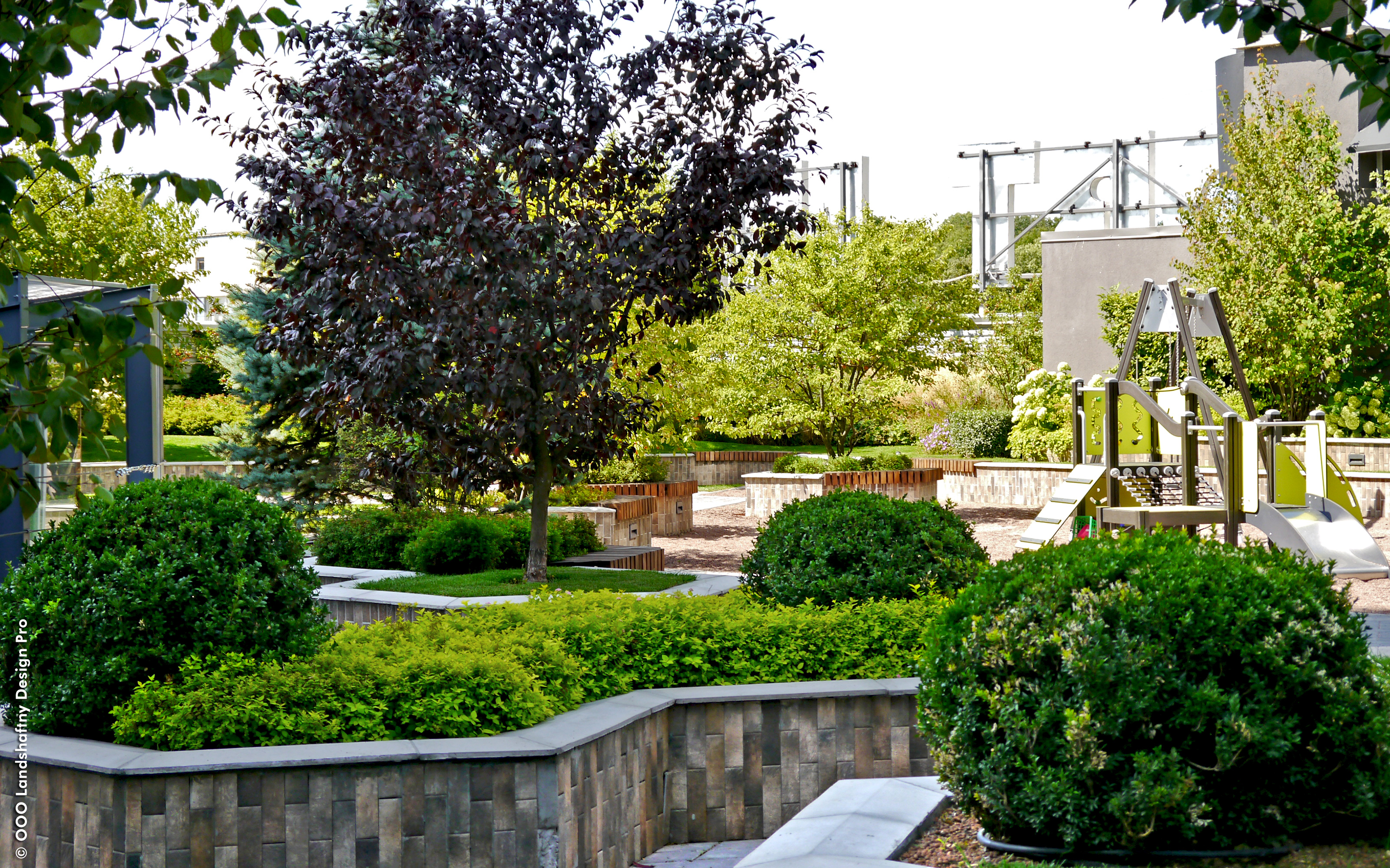 The green roof offers space for recreation and serves as a green lung in a densely populated city. Roof garden with small trees, lawn and a playground